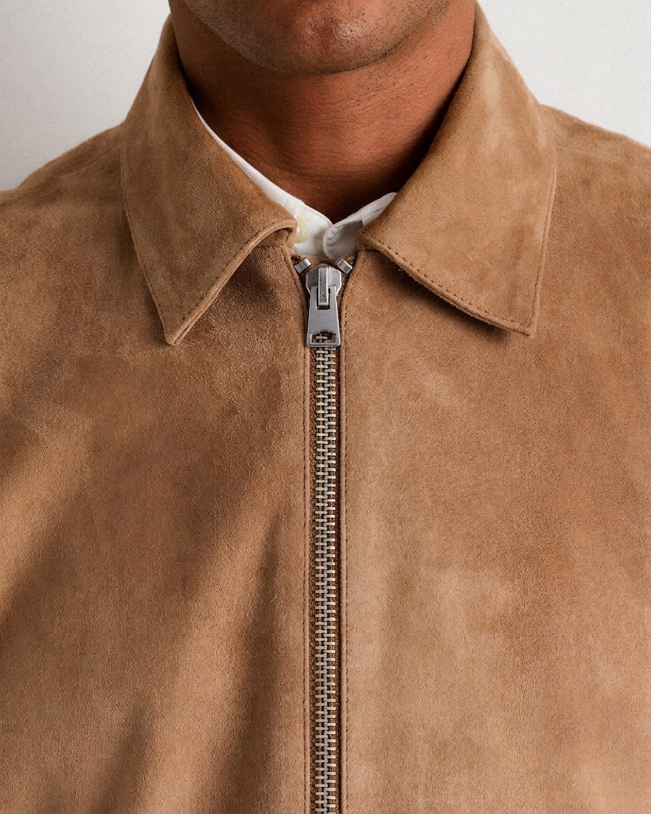 Suede Harrington Jacket – Detail Shot Close-up of suede Harrington jacket zipper and welt pocket